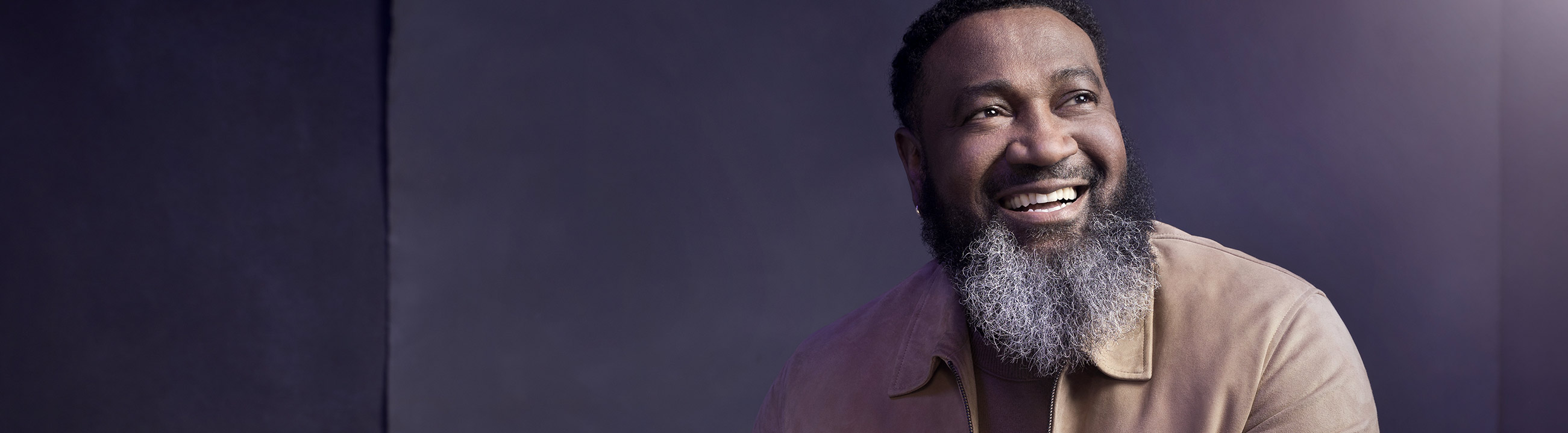 Black man seating on a chair smiling image